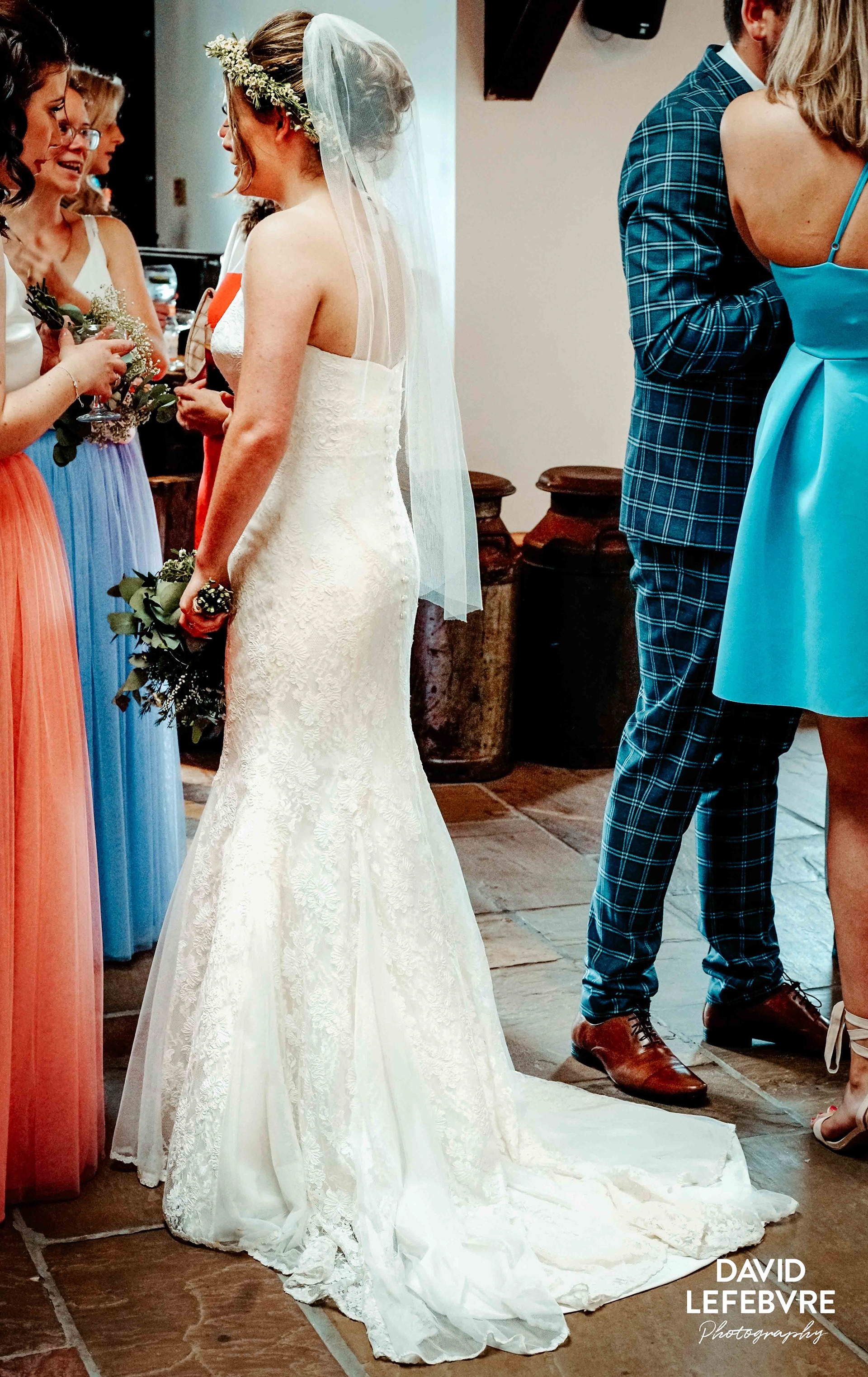bride stood with friends with questions at owen house barn wedding