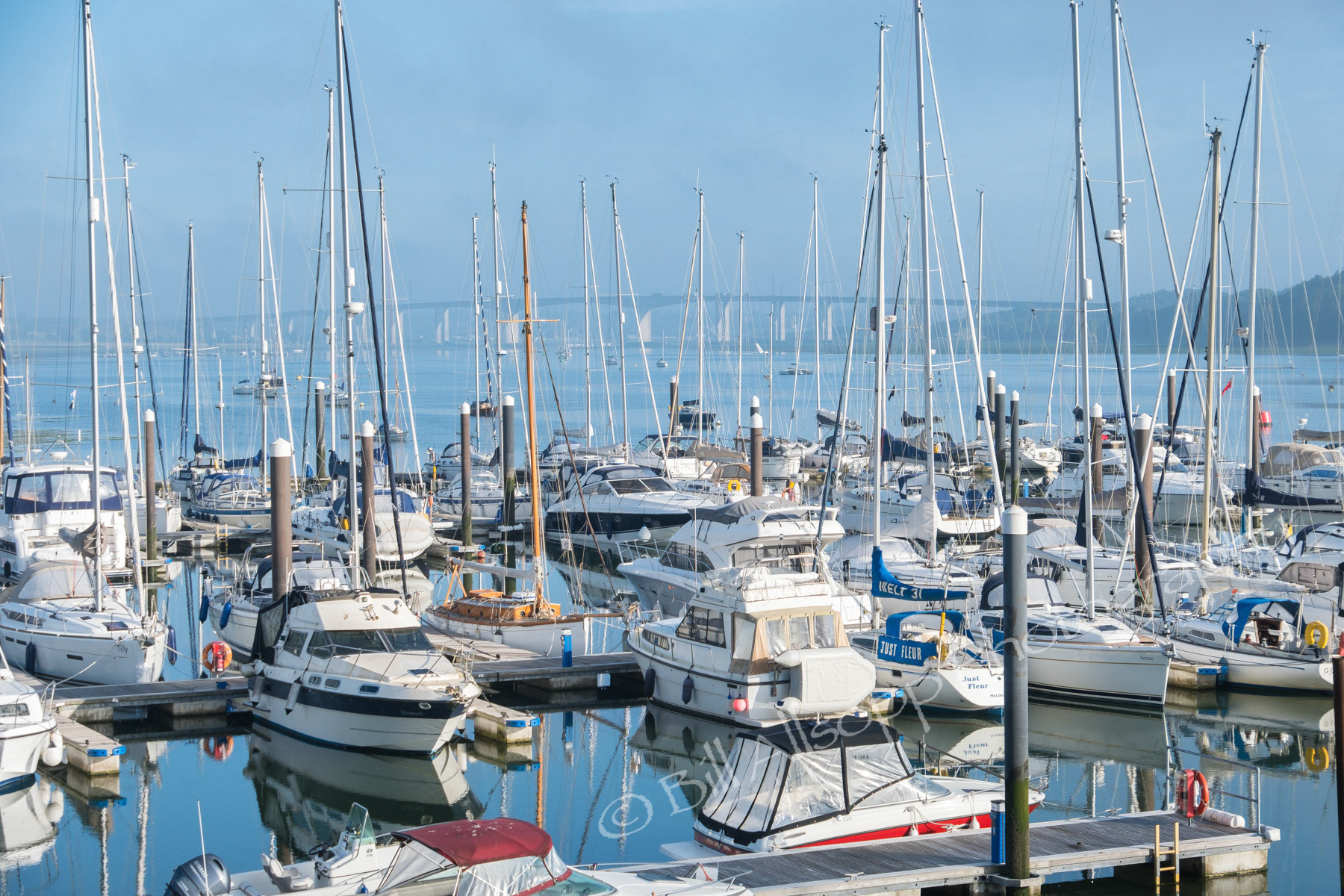 Boats in Wolverstone Marina on the river Orwell in Suffolk with the Orwell bridge in the distance.