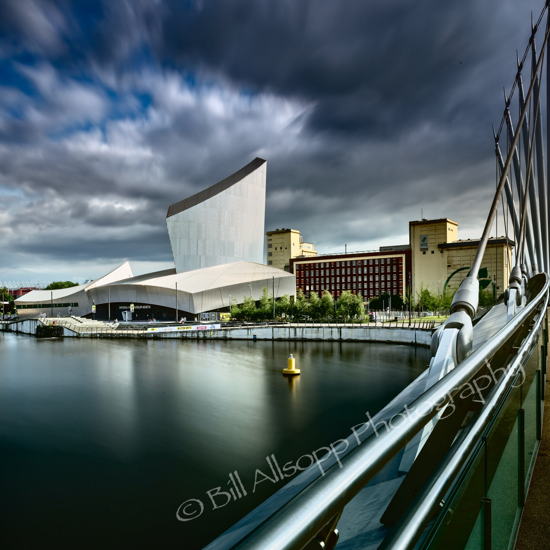 The Imperial War Museum North seen from the footbridge across the basin.