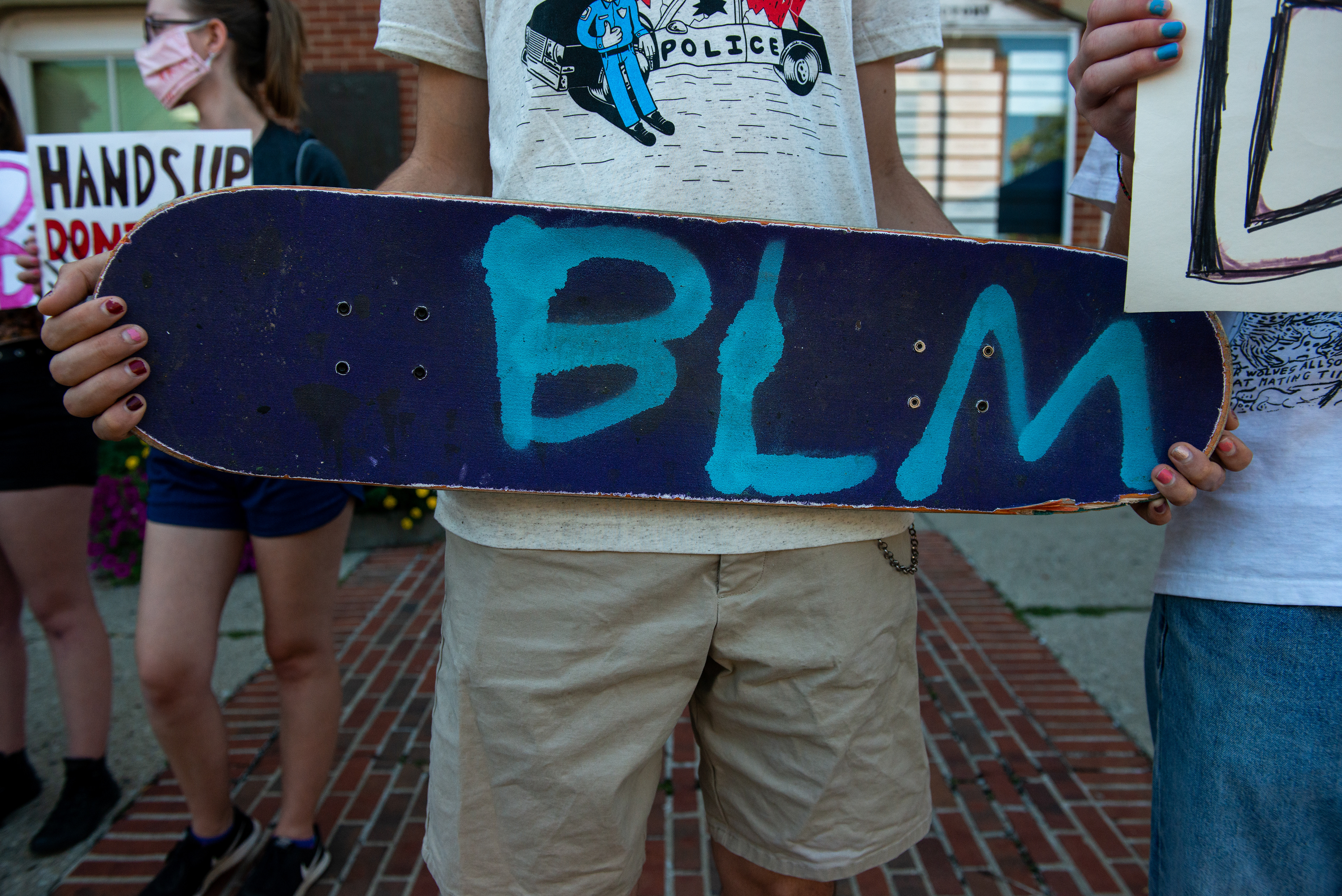 Nicholas Antonuccio holds his spray-painted skateboard in lieu of a sign at the Black Lives Matter protest in Athens, Ohio on Sept. 5, 2020.
