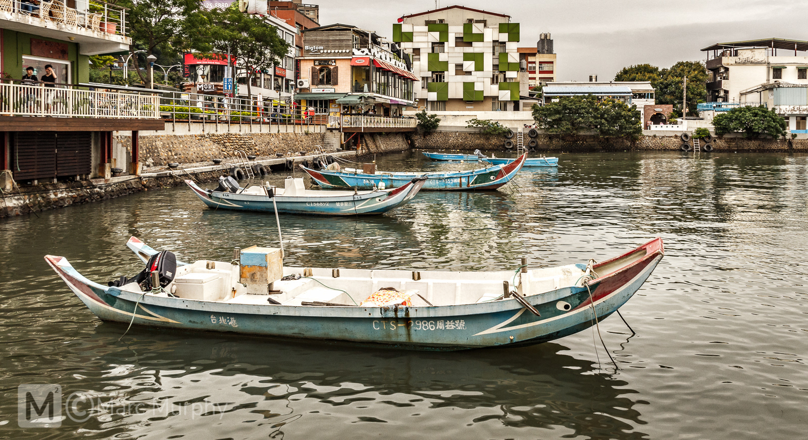 De-Saturated Blue Fishing Boats Floating in the Hobe Fishing Harbor of the Tamsui District in Taipei Taiwan