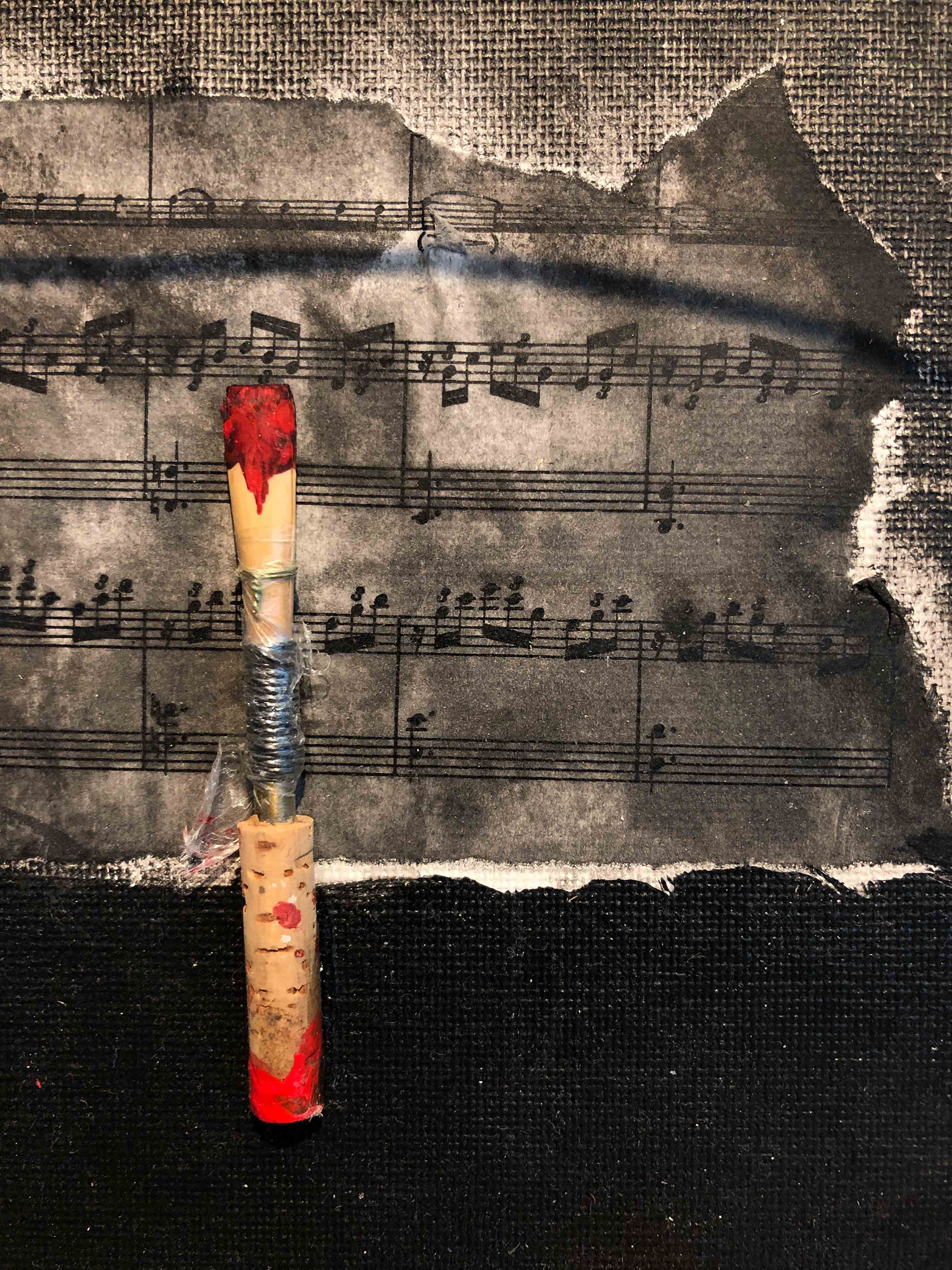 Detail showing oboe reed and sheet music