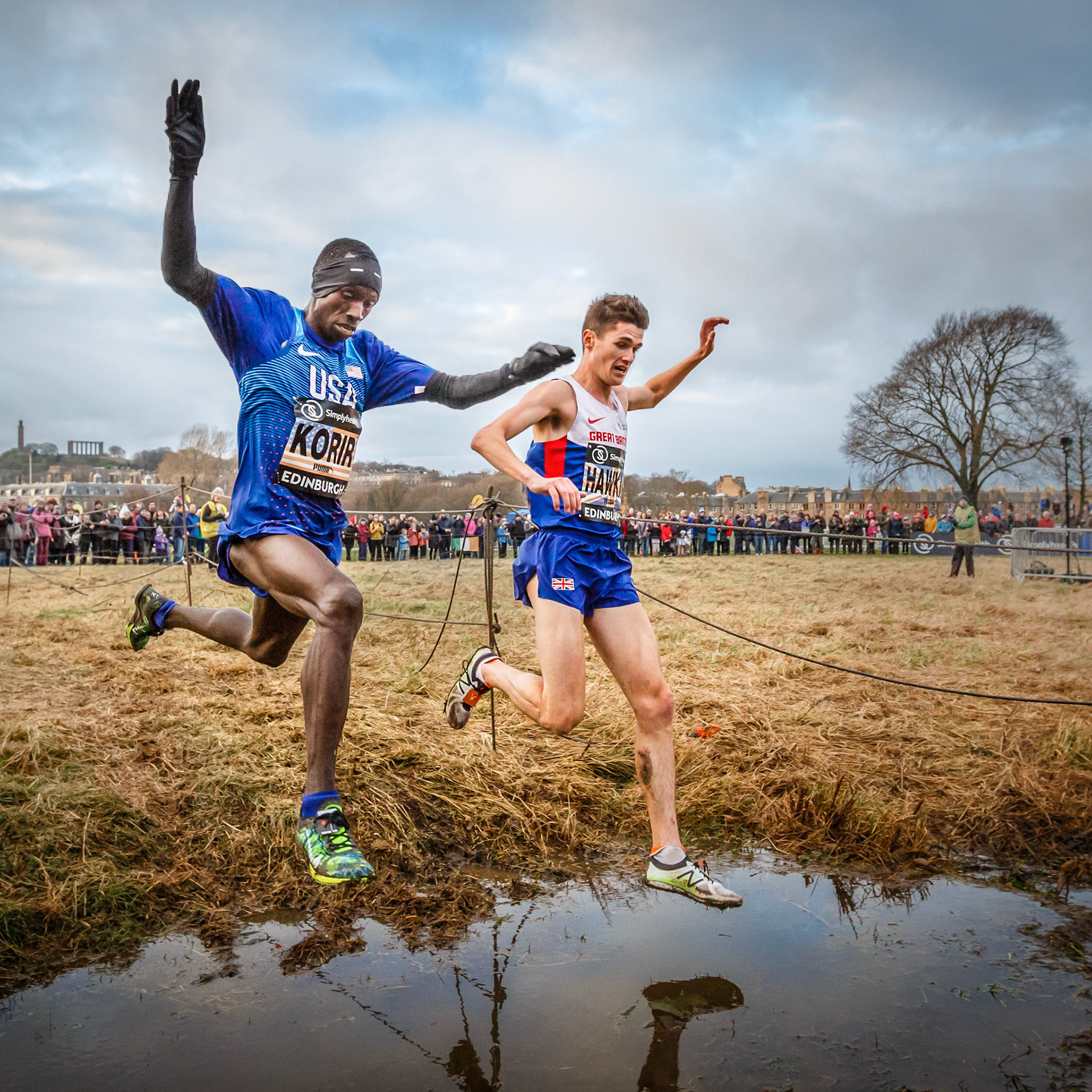 Cross country runners competing in the Great Edinburgh Cross Country Run in January 2017. For the last lap of the race I positioned myself next to the water jump with the hope of capturing the runners leaping. Occasionally runners fall here, so they need to be confident of a safe landing. Here the two leaders take a leap of faith, each hoping not to lose ground over the water jump.