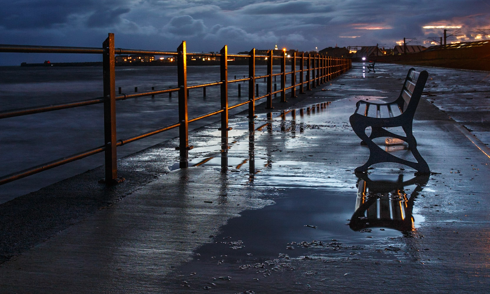 At the end of a wild and windy day during an autumn break to the Ayrshire coast. The empty benches, the discarded bottle, and the wet esplanade all emphasise the end of season feel.