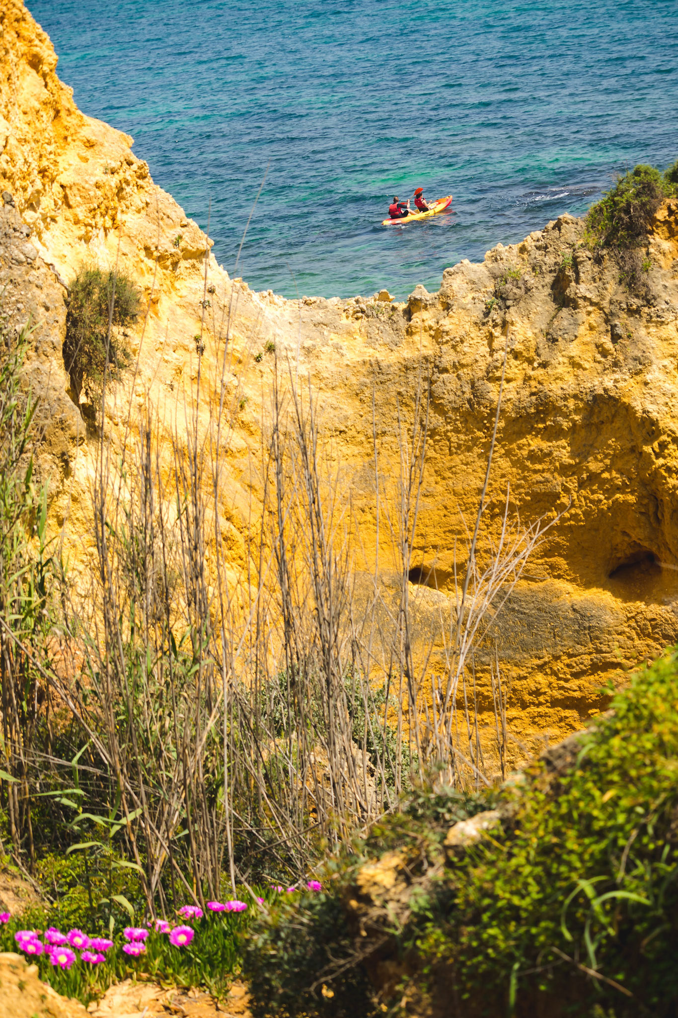 Beach paradise view. Yellow sand and Rocks in the Algarve, Portugal. Nice sunbeam and shadow.