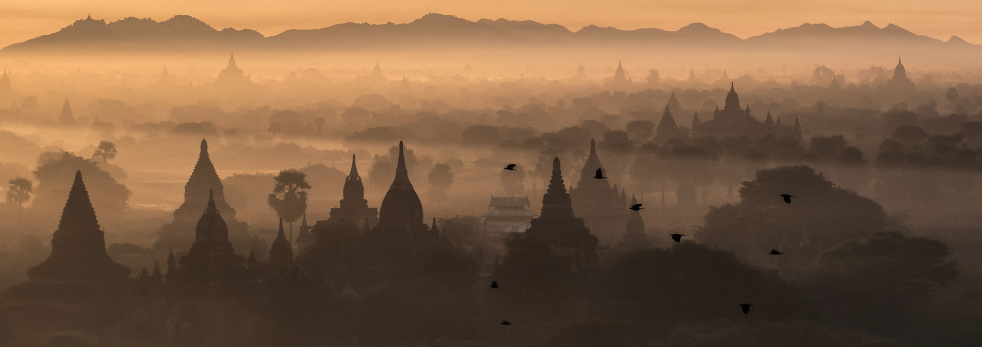 Foggy sunrise in Bagan. The shot made from hot air balloon flying over Bagan Archaeological Area