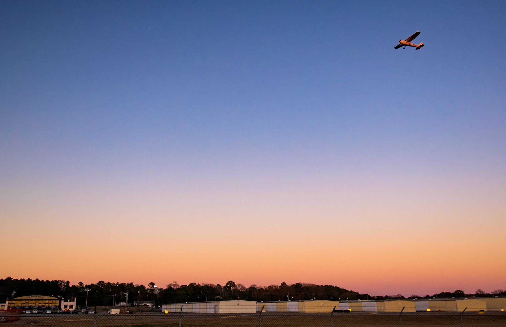 Plane takes off from Owens Field at Sunset