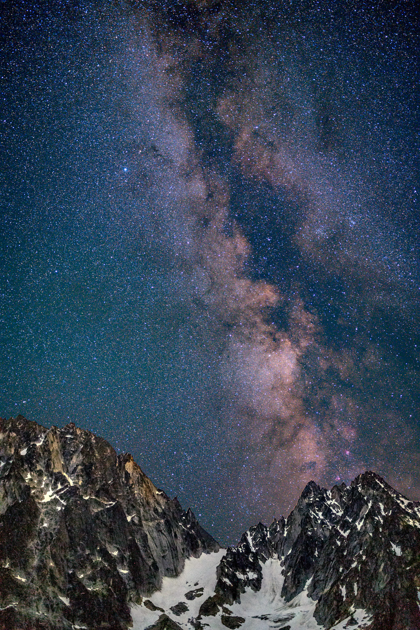 The milky way rises over Dragontail and Colchuck peaks in the Alpine Lakes Wilderness of WA.