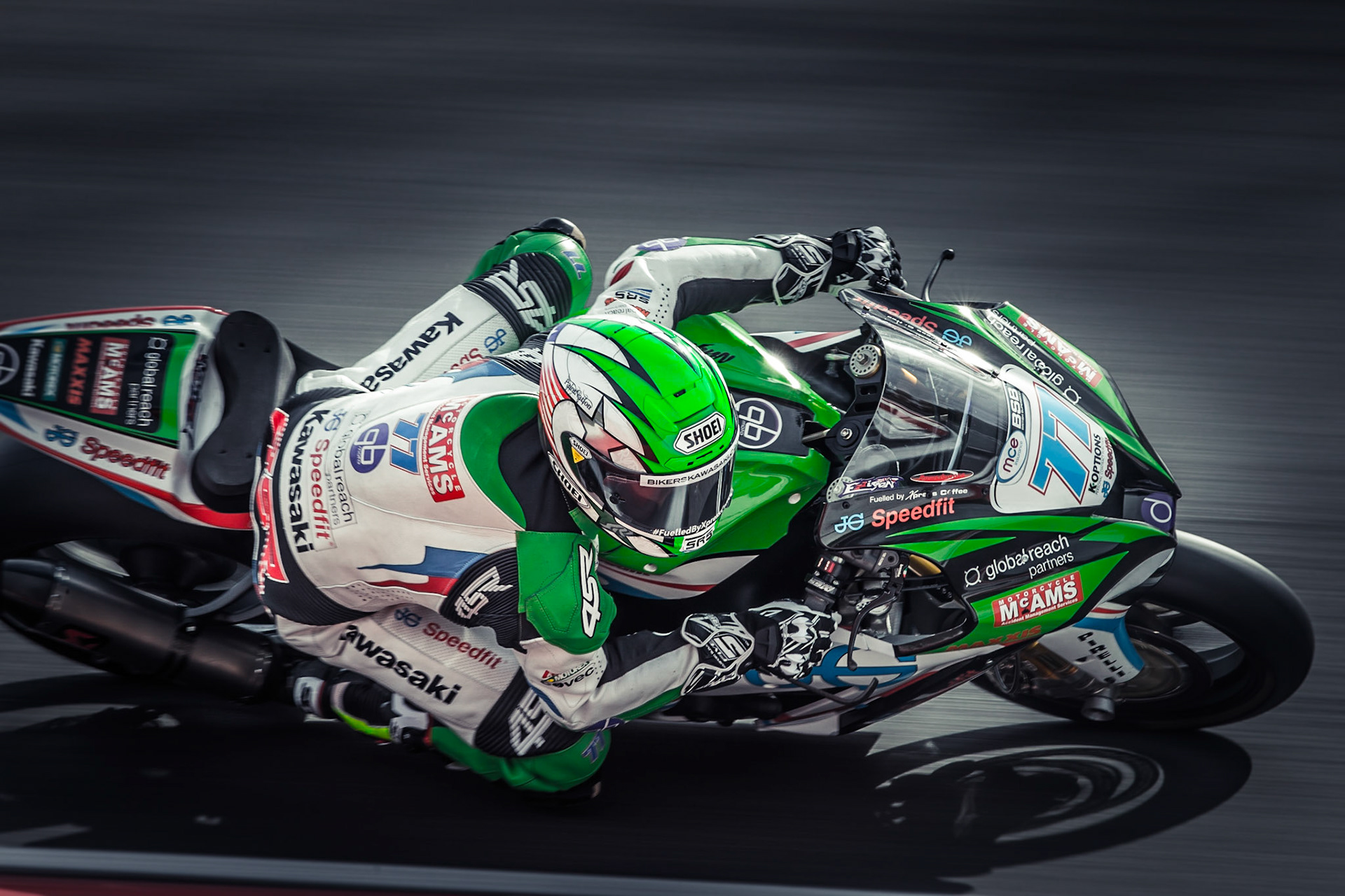James Ellison on a 'JG Speedfit Kawasaki' concentrates as he takes Druid's Hairpin during a Superbike race at Brand's Hatch.