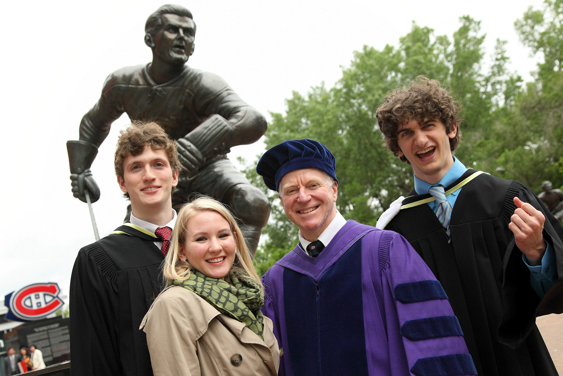  Professor James Coulton is surrounded by happy graduates and an equally-enthused bronze Rocket Richard. June 2012.