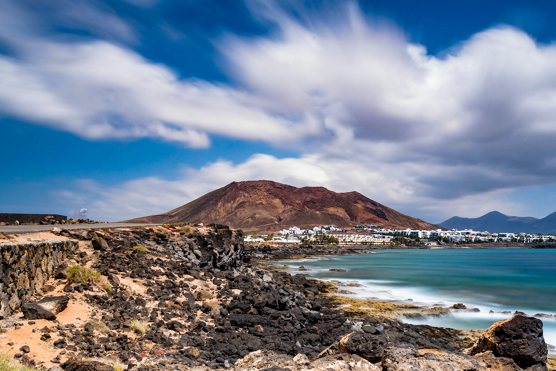 Playa Blanca, Lanzarote A long exposure of around 2 minutes,taken using a very dark filter creates the milky smooth effect of the water and movement in the clouds.
