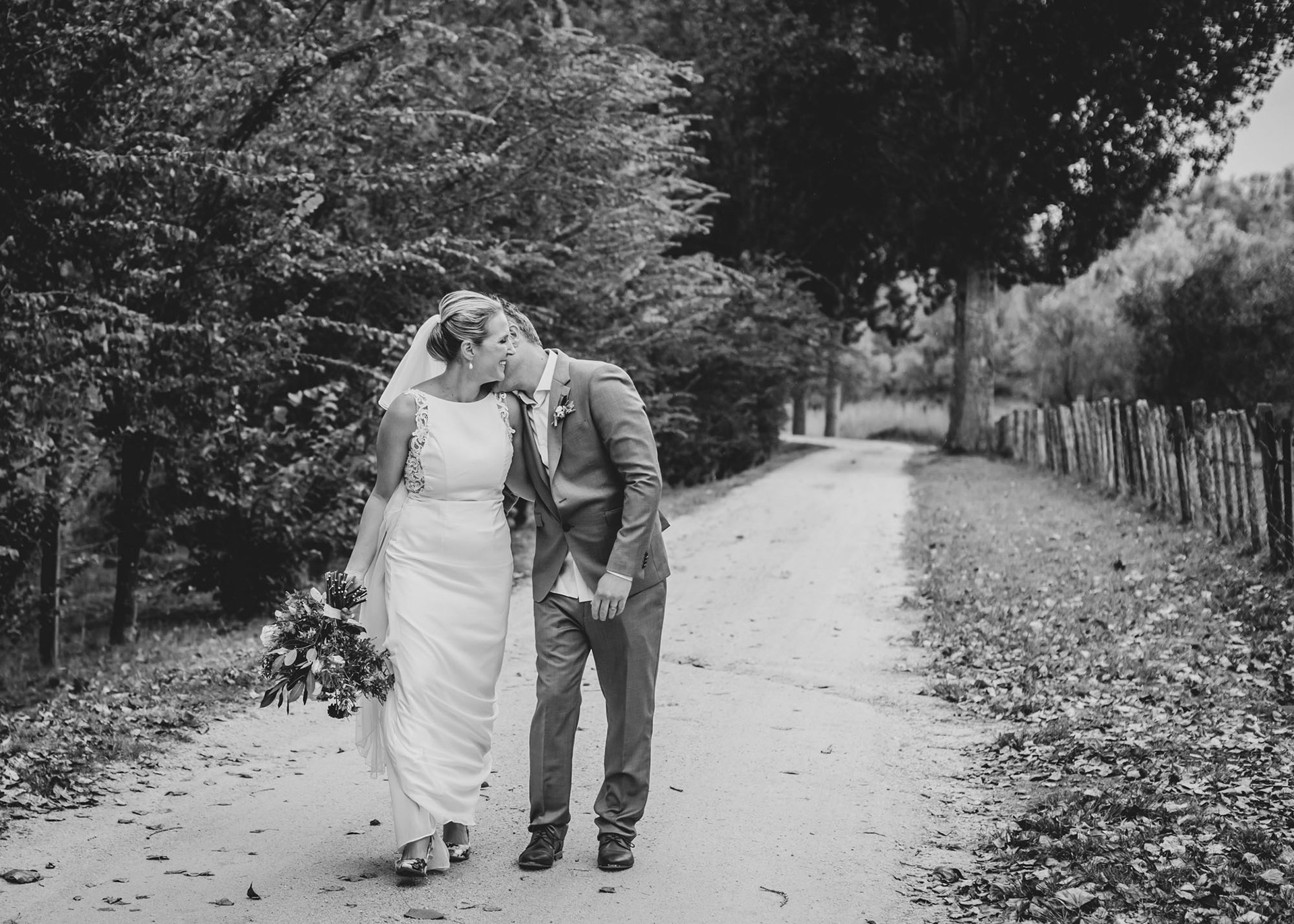 Bride Esther with her groom Chade walking together after getting married at Hawke's Bay Black Barn Olive Shed