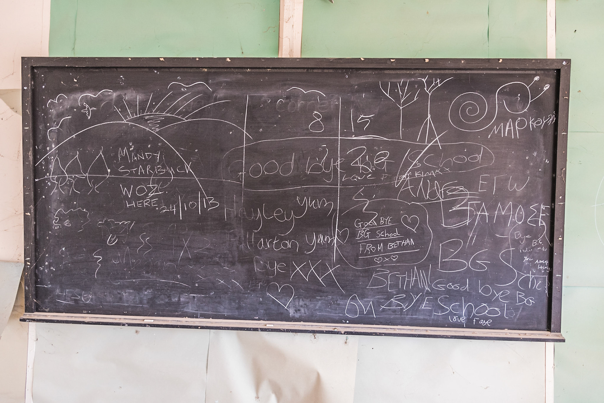 Chalkboard in an abandoned classrooms at Berengaria Village in Limassol, Cyprus. Wirtten on the board are farewell messages from the students.