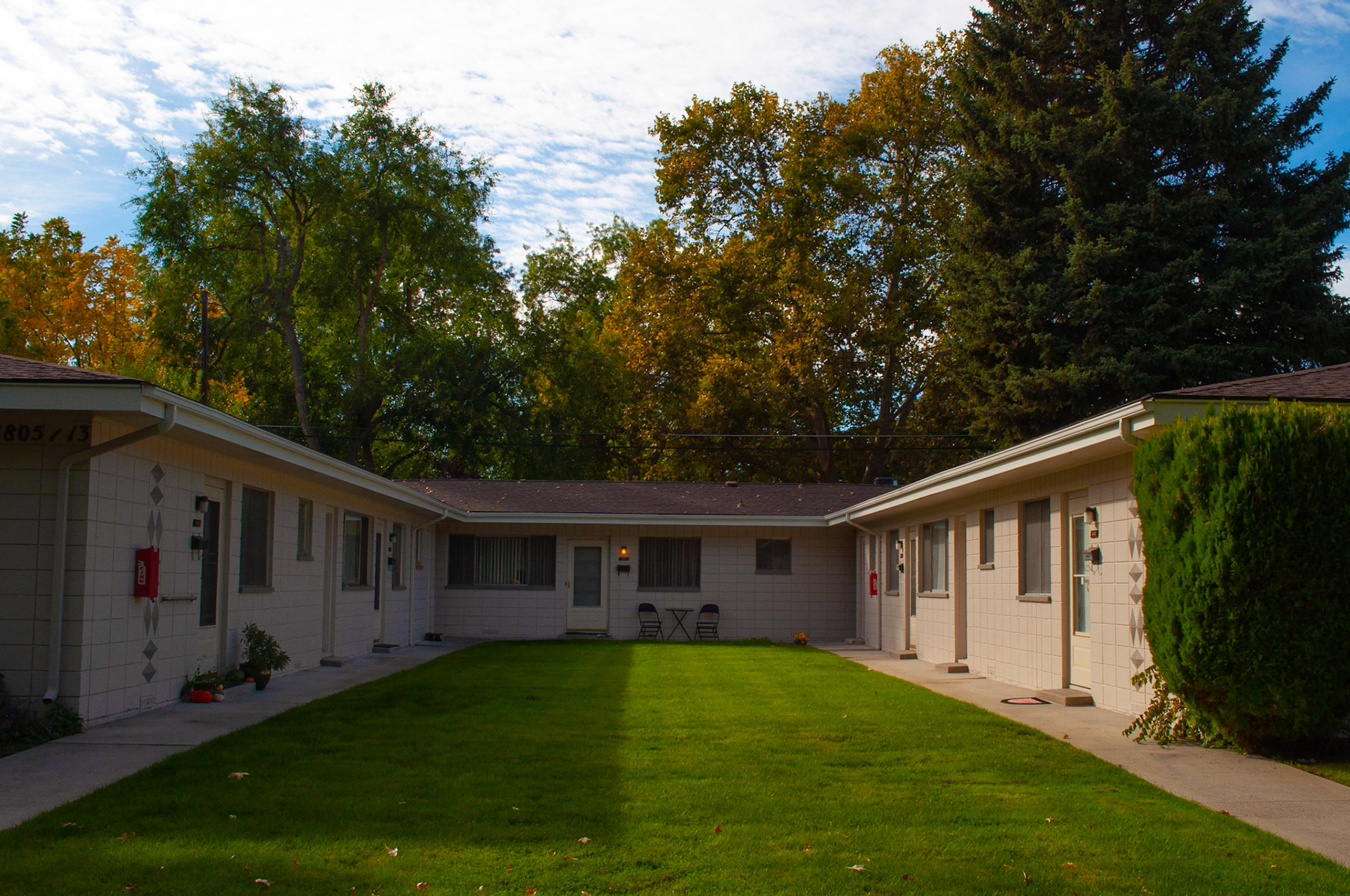 Two Sides: Small town homes, , captured the symmetry of the shadow casting down the center of the complex creating a light and dark side, 20201011, Harrison Blvd, MILLER, I enjoy this time of year and this particular street very much the balance of the lighting drew me to compose this shot. Camera Settings: Nikon D5000 ISO 200, 24mm f/18, 1/200s