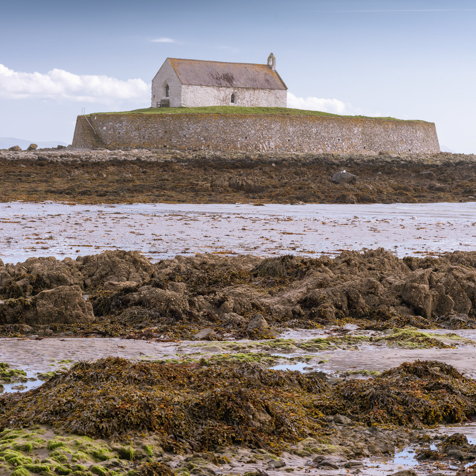 St Cwyfan's Church is a Grade II*-listed medieval church in Llangadwaladr, Anglesey, Wales. Located on the small tidal island of Cribinau, it is popularly known as the "Church in the Sea" (or eglwys bach y mor in Welsh). The church dates from the 12th century, with some renovations made in the 19th century.