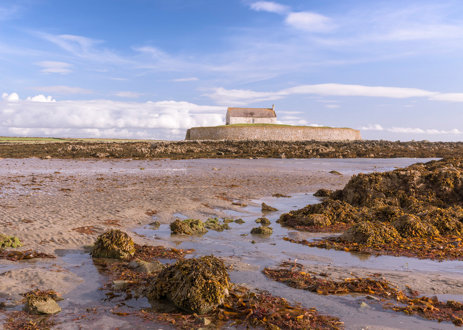 St Cwyfan's Church is a Grade II*-listed medieval church in Llangadwaladr, Anglesey, Wales. Located on the small tidal island of Cribinau, it is popularly known as the "Church in the Sea" (or eglwys bach y mor in Welsh). The church dates from the 12th century, with some renovations made in the 19th century.