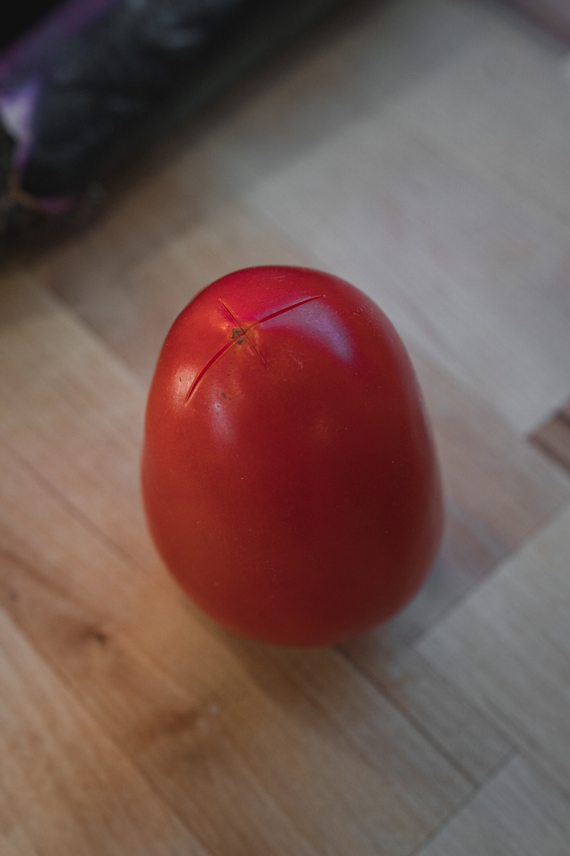 Notch both ends of the tomato like this
