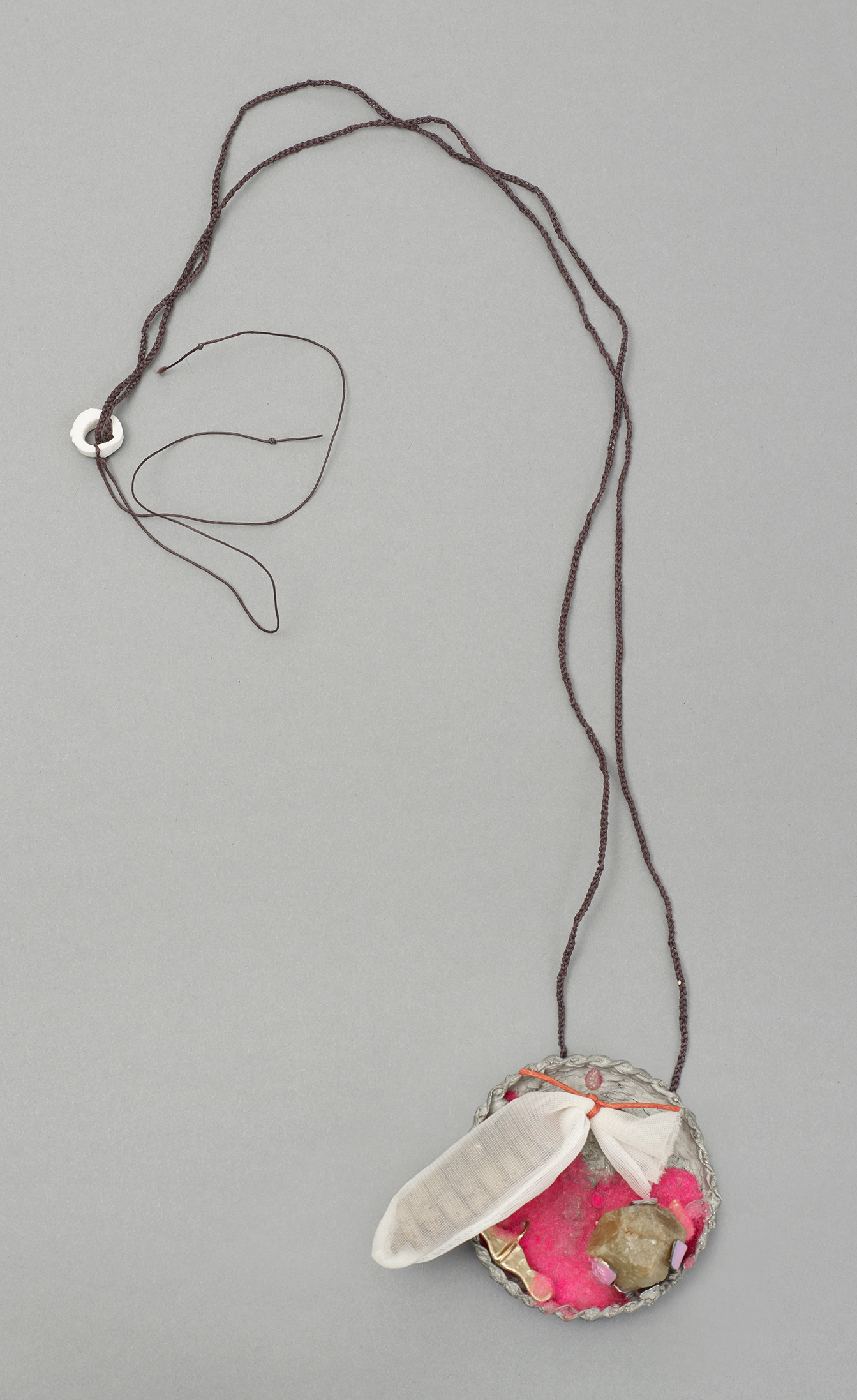 No.9 Item: Pendent H 42cm W 8cm D 3cm Materials: rattle from snake, gold, silver, pewter, green garnet, flocking, finger from glove, military waxed tread, porcelain, nail varnish.Photo credit: Michael Pollard