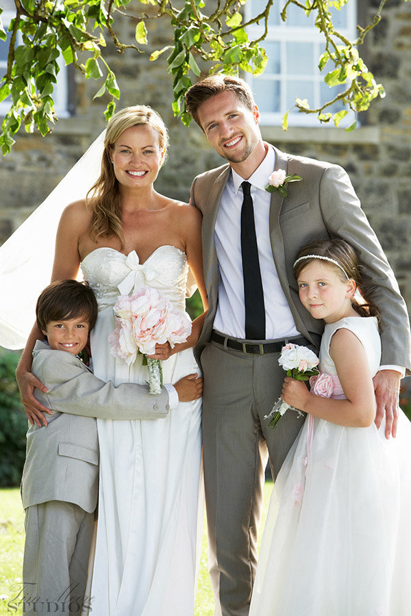 Bride And Groom With Bridesmaid And Page Boy At Wedding