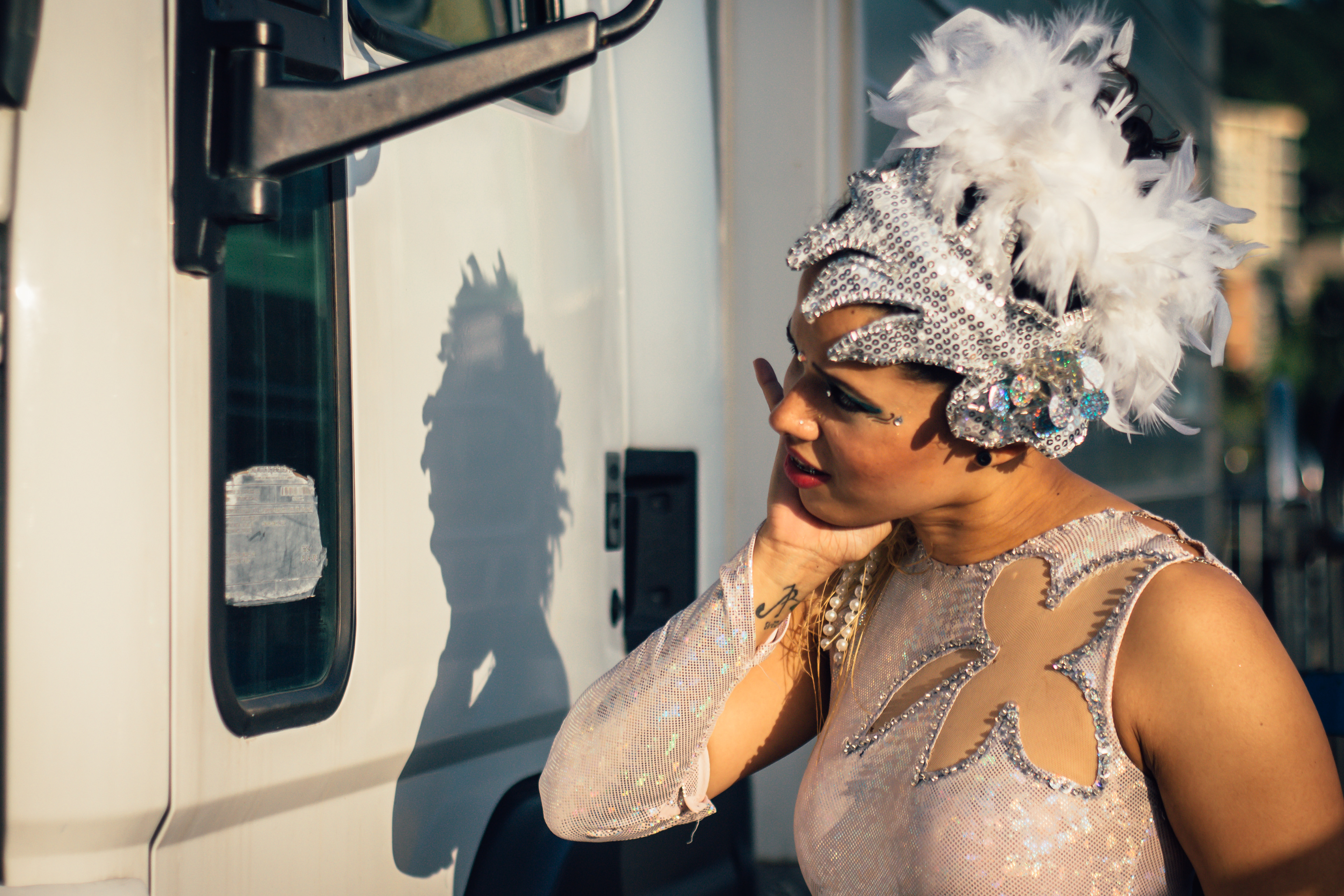 A dancer of the Great Mexican Circus uses the mirror on one of the circus's trucks to fix her makeup. Caracas, 2015