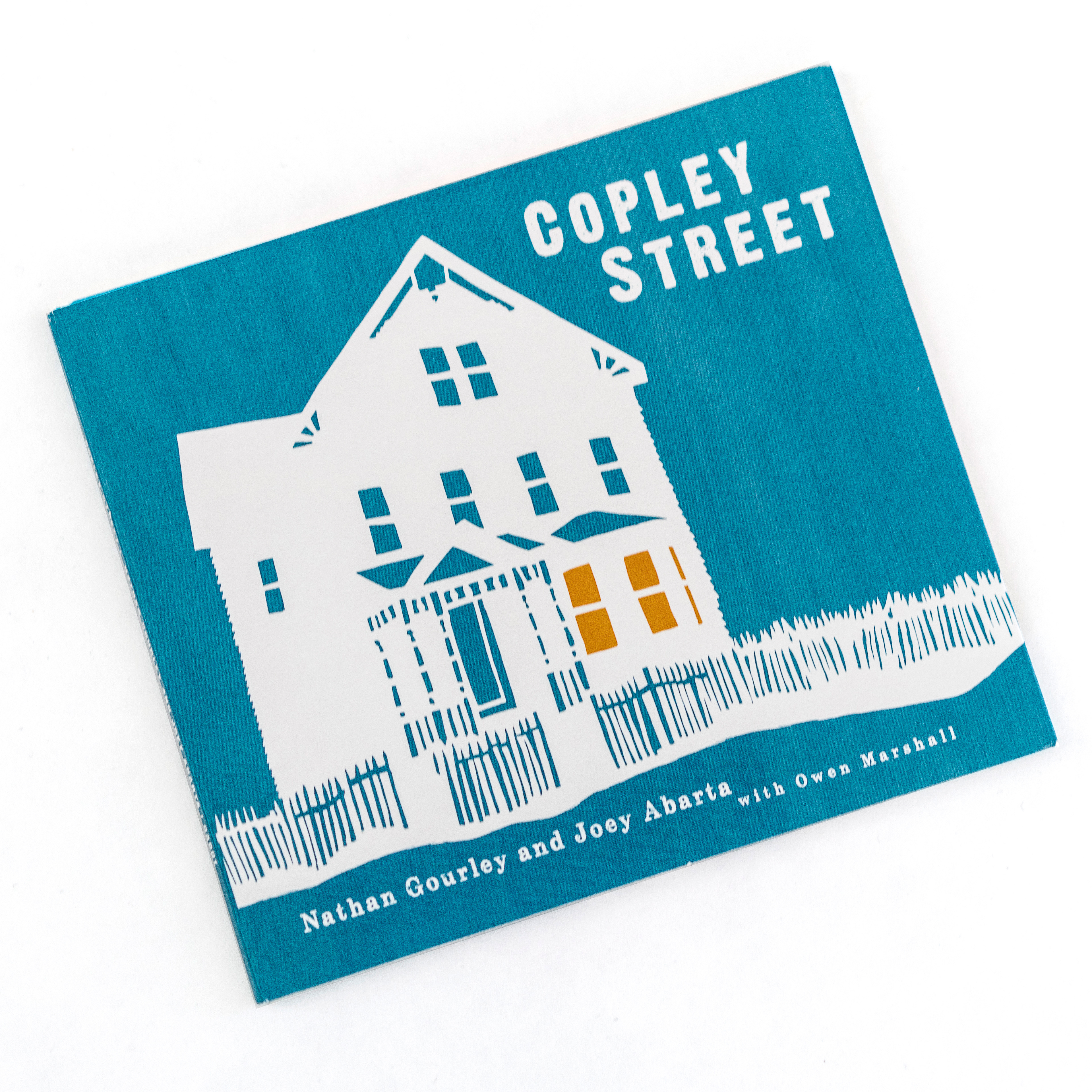 Nathan Gourley and Joey Abarta's "Copley Street." Joey and Nathan commissioned an original paper cut of their house on Copley Street, which we scanned and colored for the cover of this album, giving it a homemade feel. I used an antique map of their neighborhood in Boston as a background image for the liner notes inside.