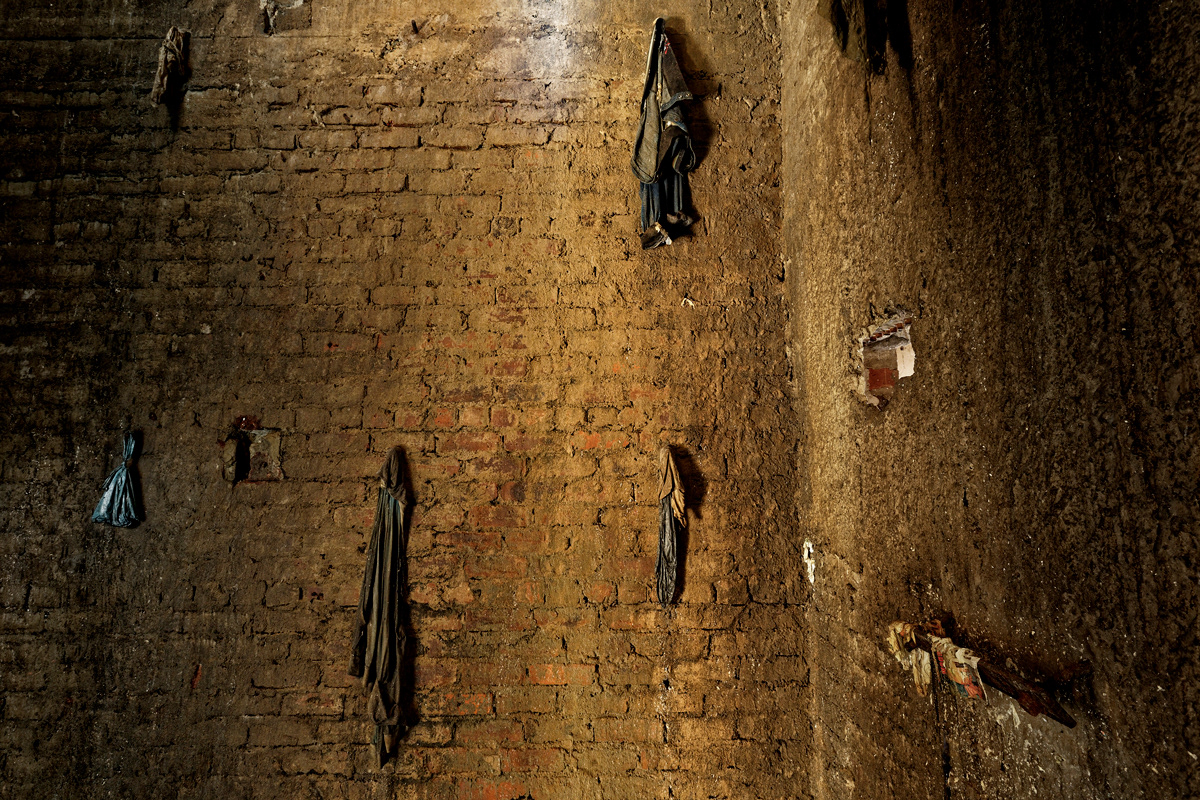 Elevator Shaft 2014-2016 Photographic Print Fine Art Cotton Rag A0. The elevator shaft of Dark City was filled with four stories of trash including the basement and elevator pit. All metal had been stripped from the elevator to be sold as scrap metal. Residents using the shaft as a rubbish dump would throw their trash into the elevator shaft but some items would get stuck on the few pieces of metal sticking out of the wall and remain eerily suspended.