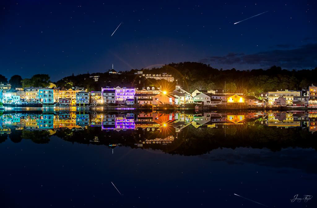 Mackinac Island at night with incredible view and reflection on the water and shooting stars