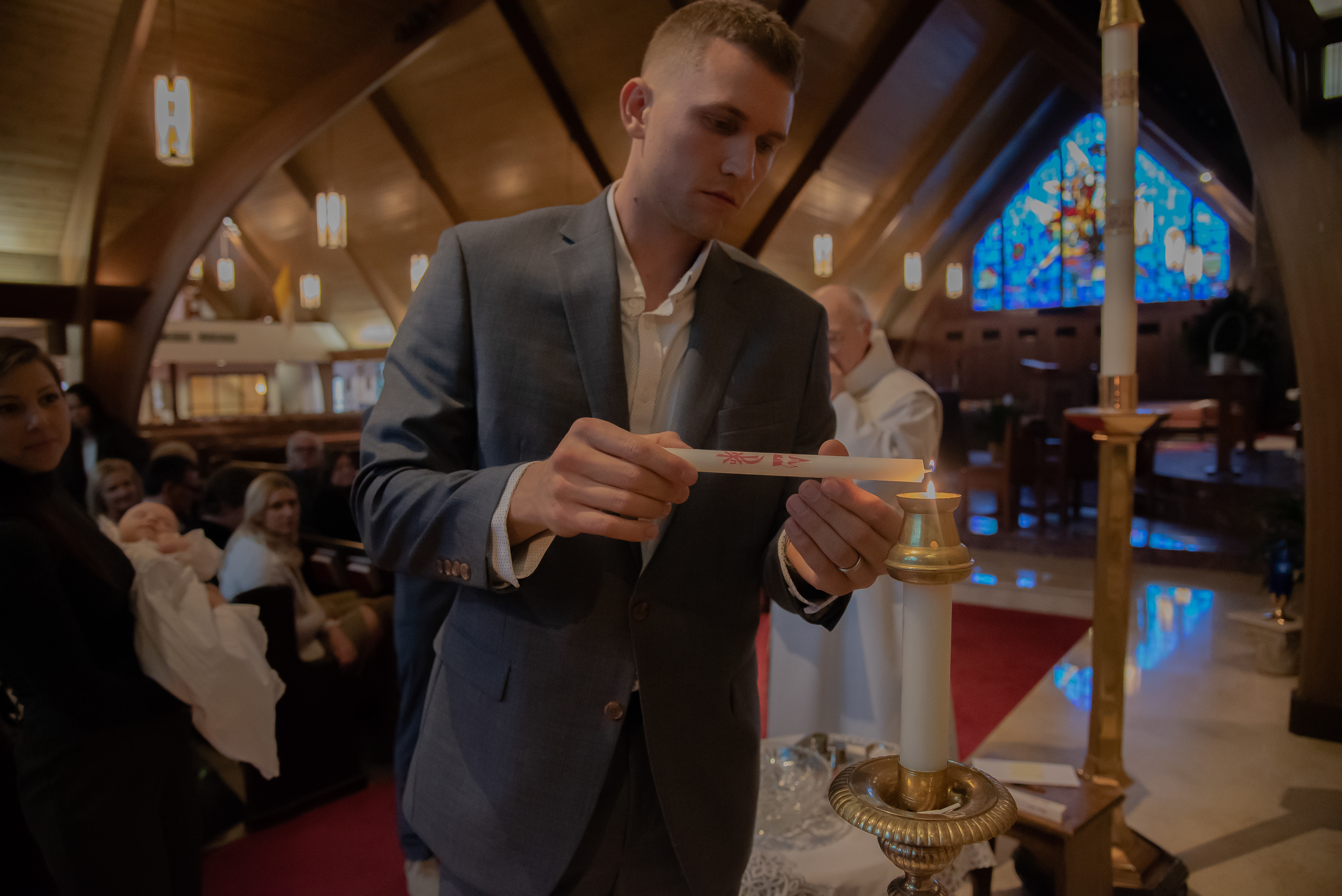 Dad lighting the candle in church.