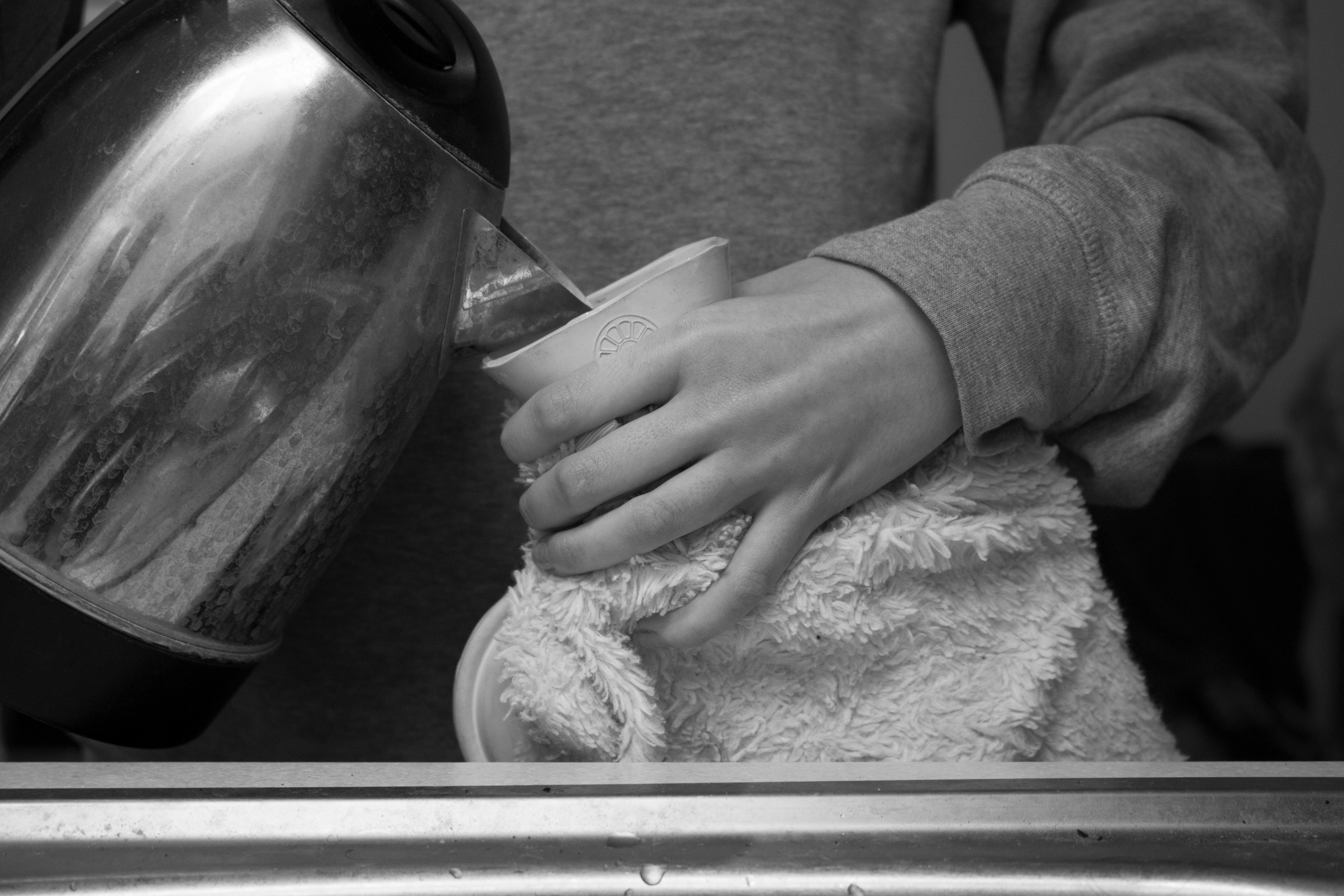 Hot water bottle being refilled