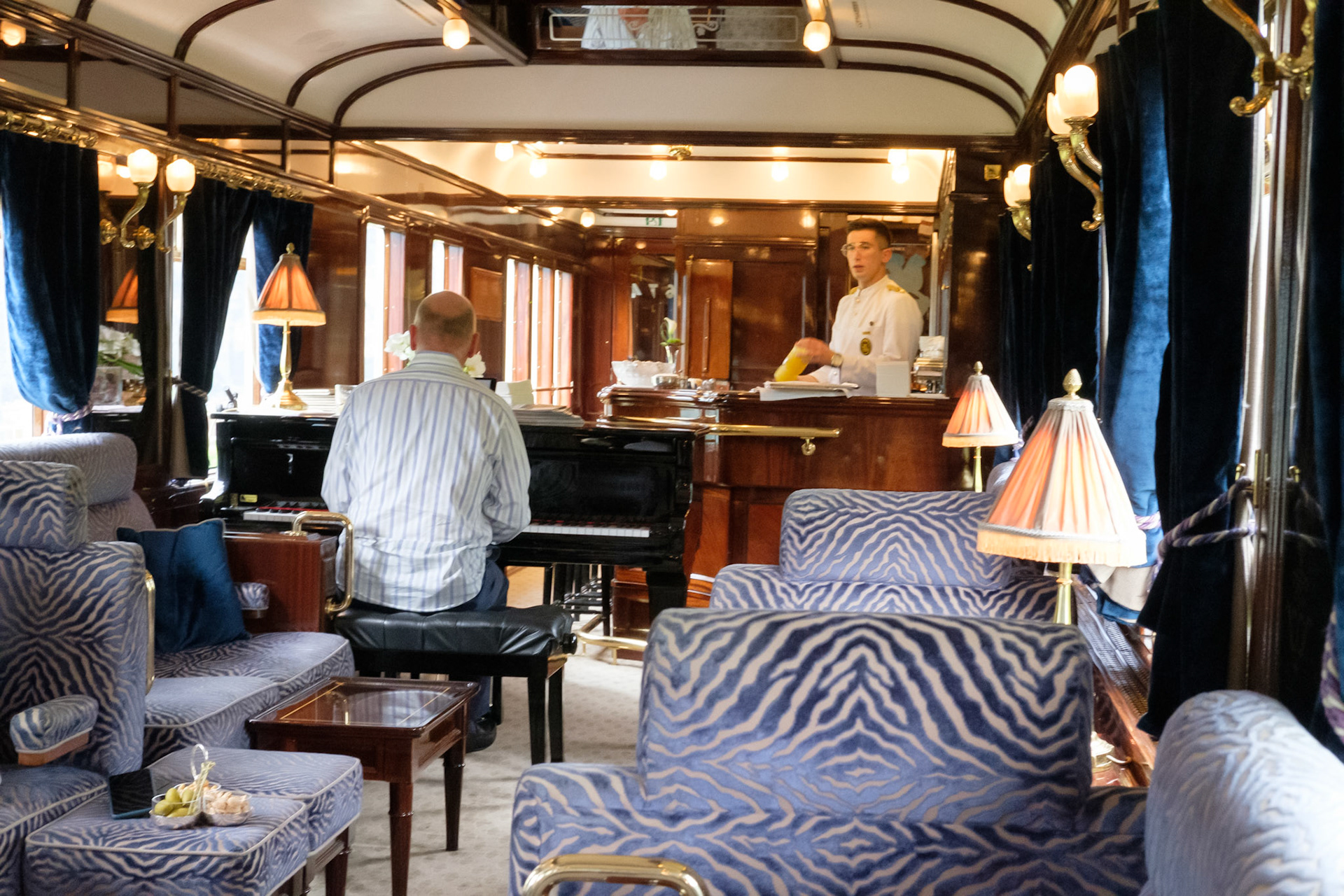 Alex playing the piano on the Orient Express