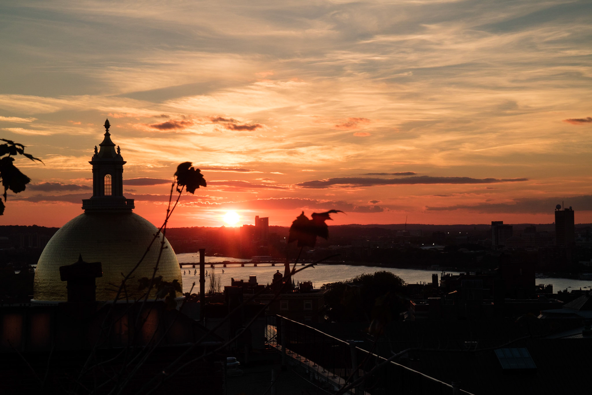 State house dome and Charles River at sunset, from roof of XV Beacon