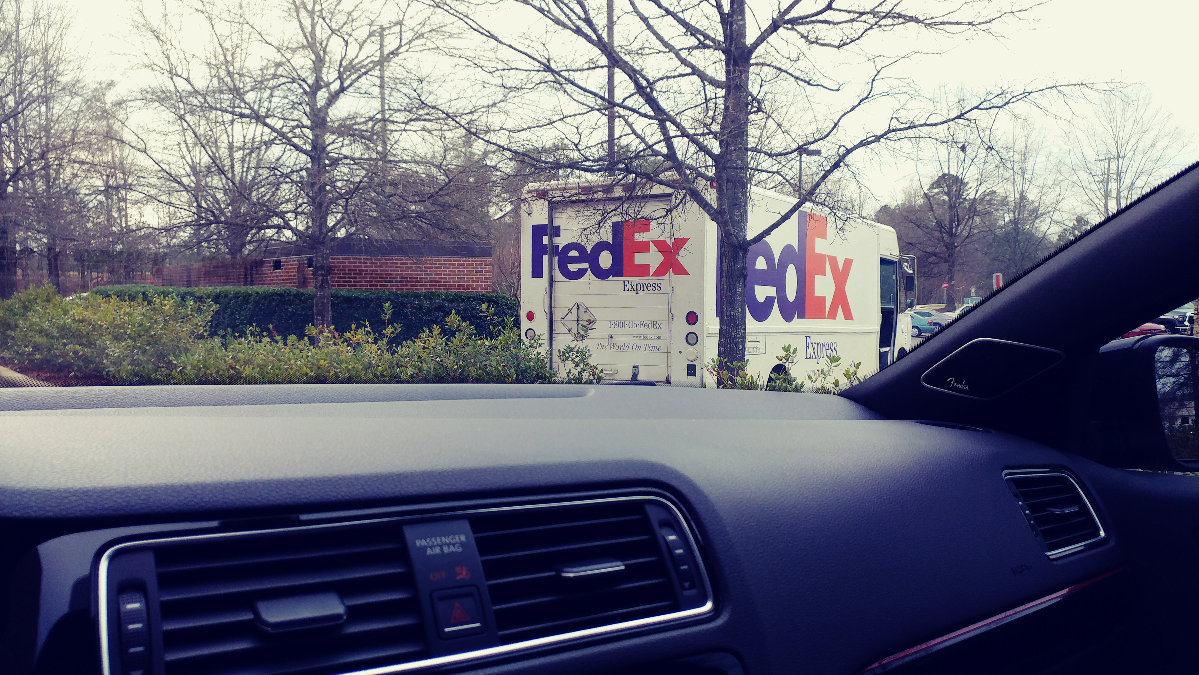 FedEx Express truck parked as driver makes delivery