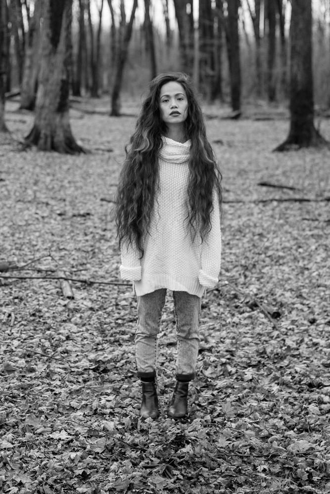 Woman stands in forest