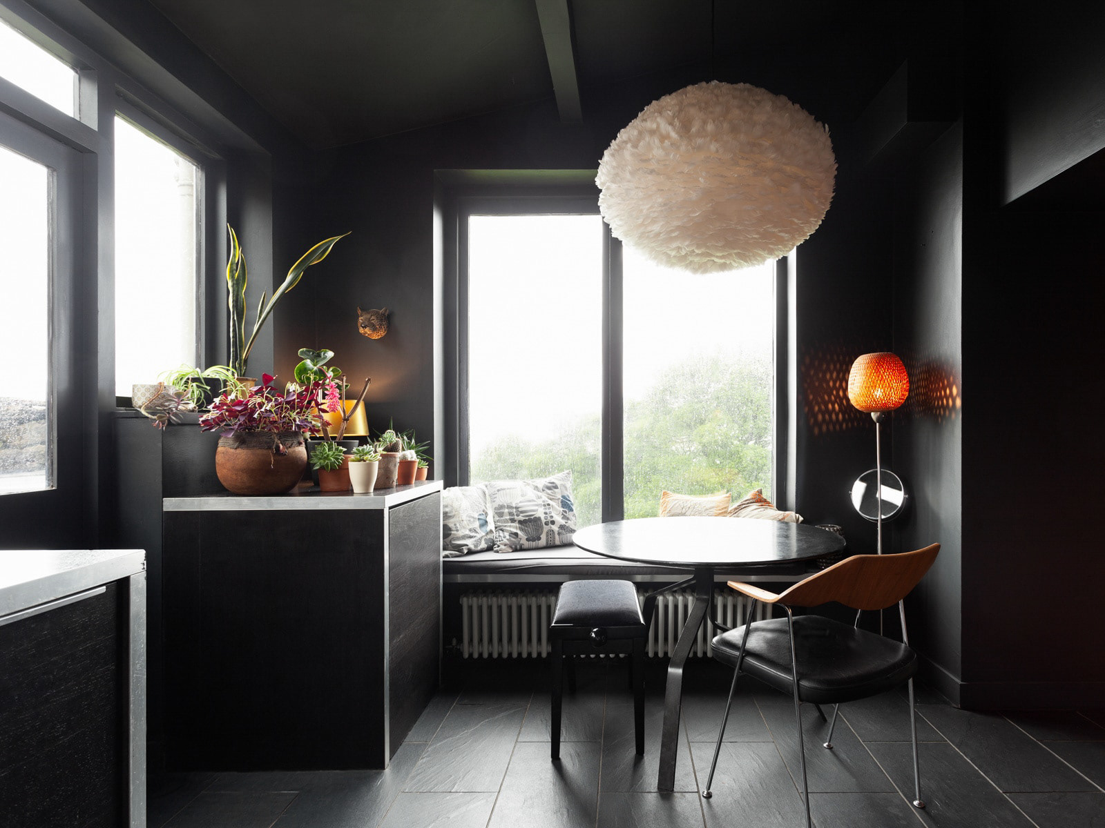 Dark interiors with large windows making the most of a small kitchen space