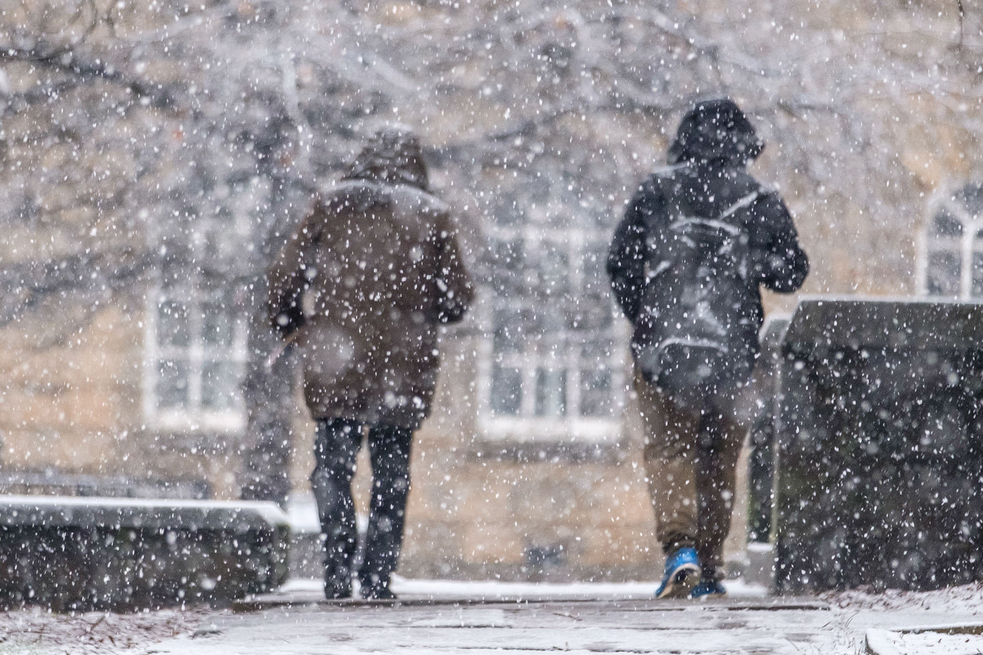 Lockdown3- Two homeless people walking in the snow outside the Cathedral Archer Project