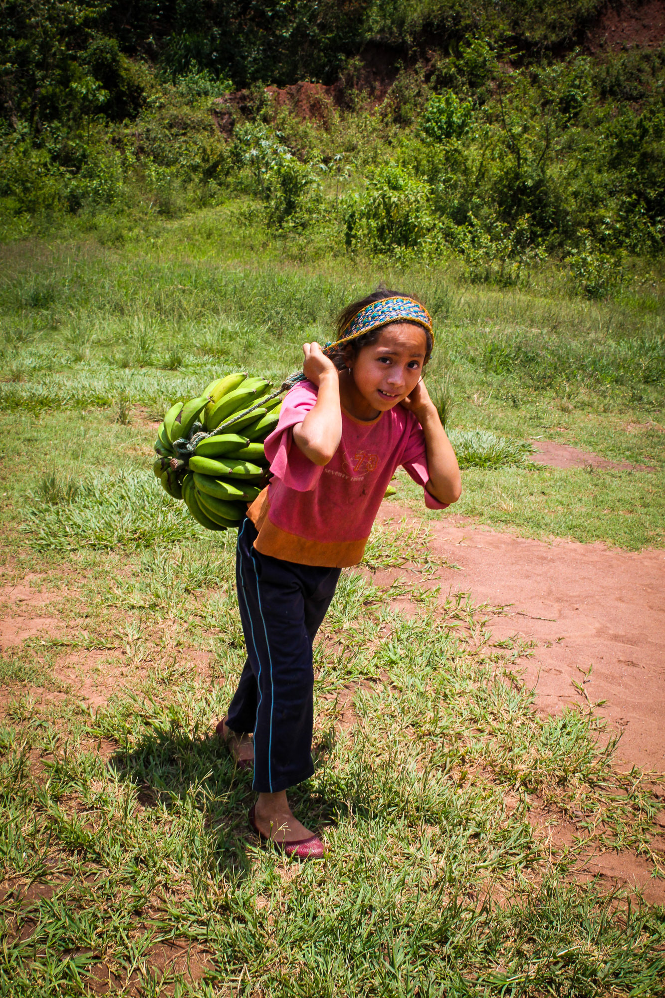 Young girl carries bananas in Chiapas.