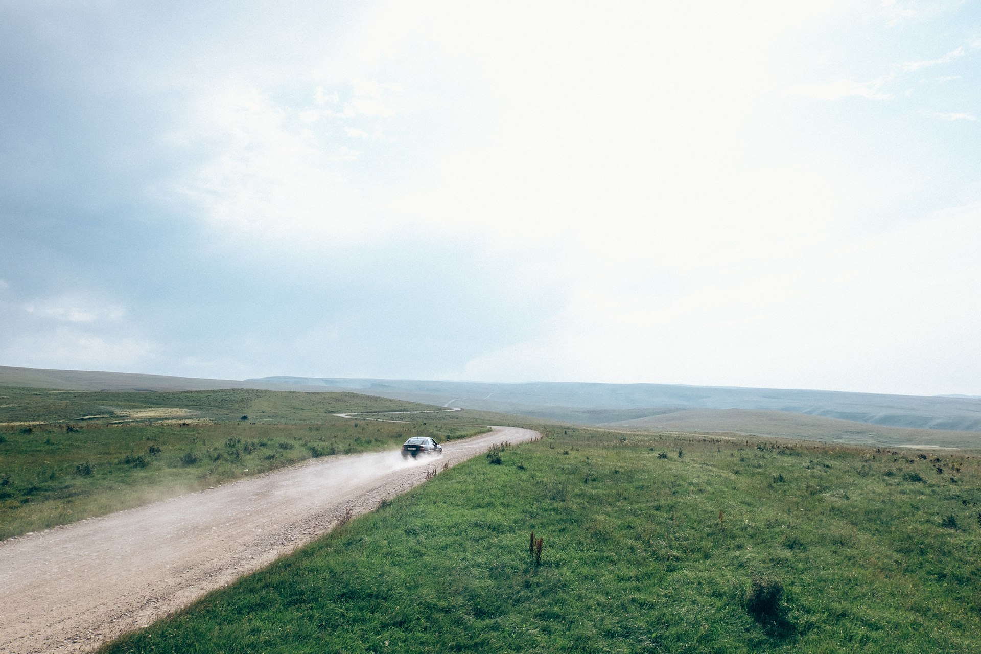 a lada driving through the caucasian vastness in russia