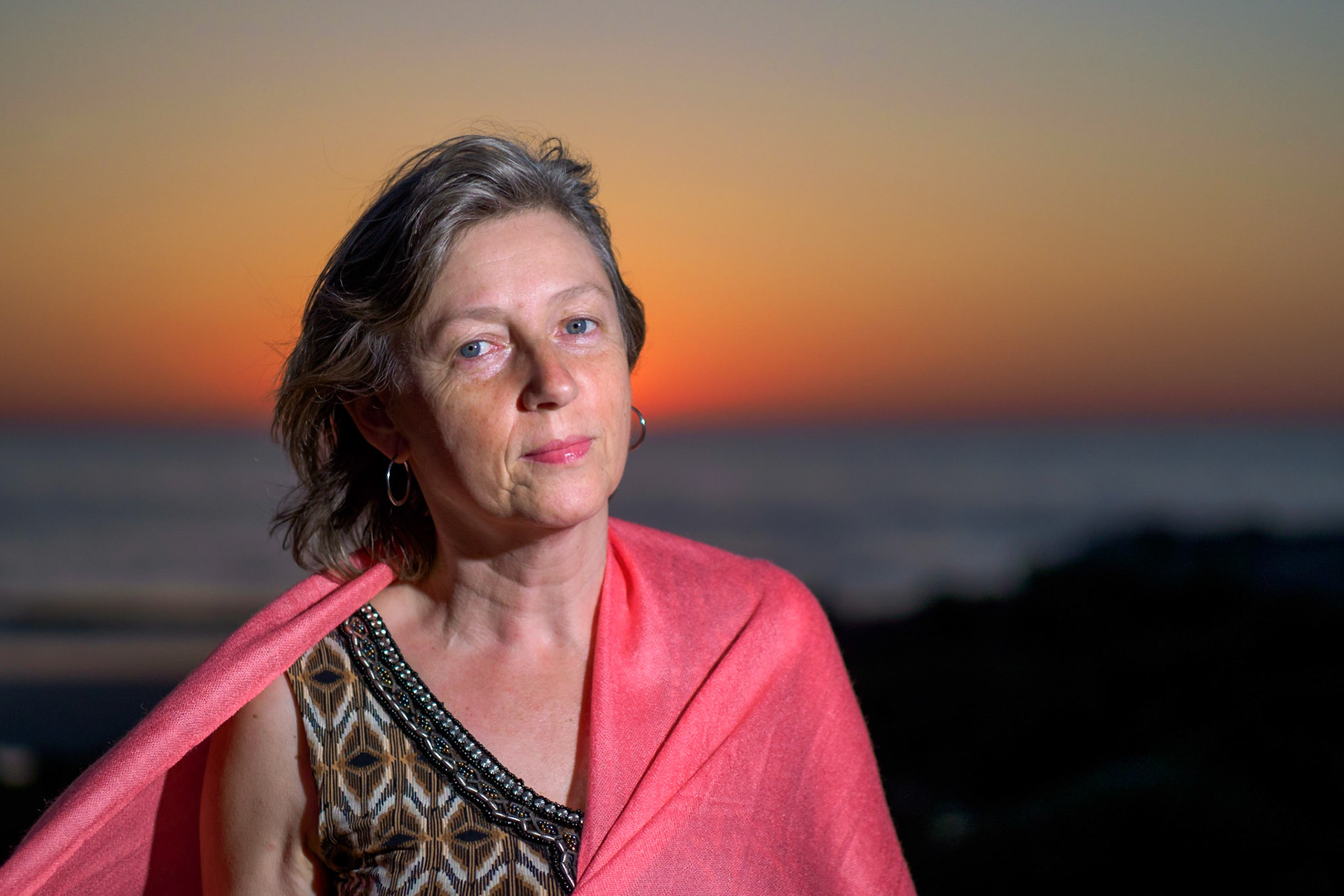 Adult female with pink scarf on the beach VIII