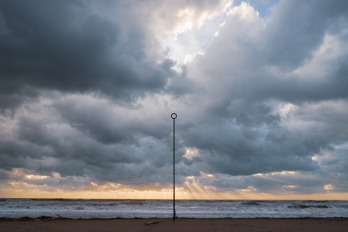 Seascape and cloudy sky, rays of sunlight through clouds (landscape photography)